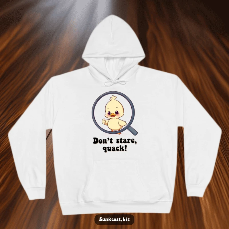 Funny duck character looking stressed while trying to get away from a giant magnifying glass, featured on a warm hoodie.